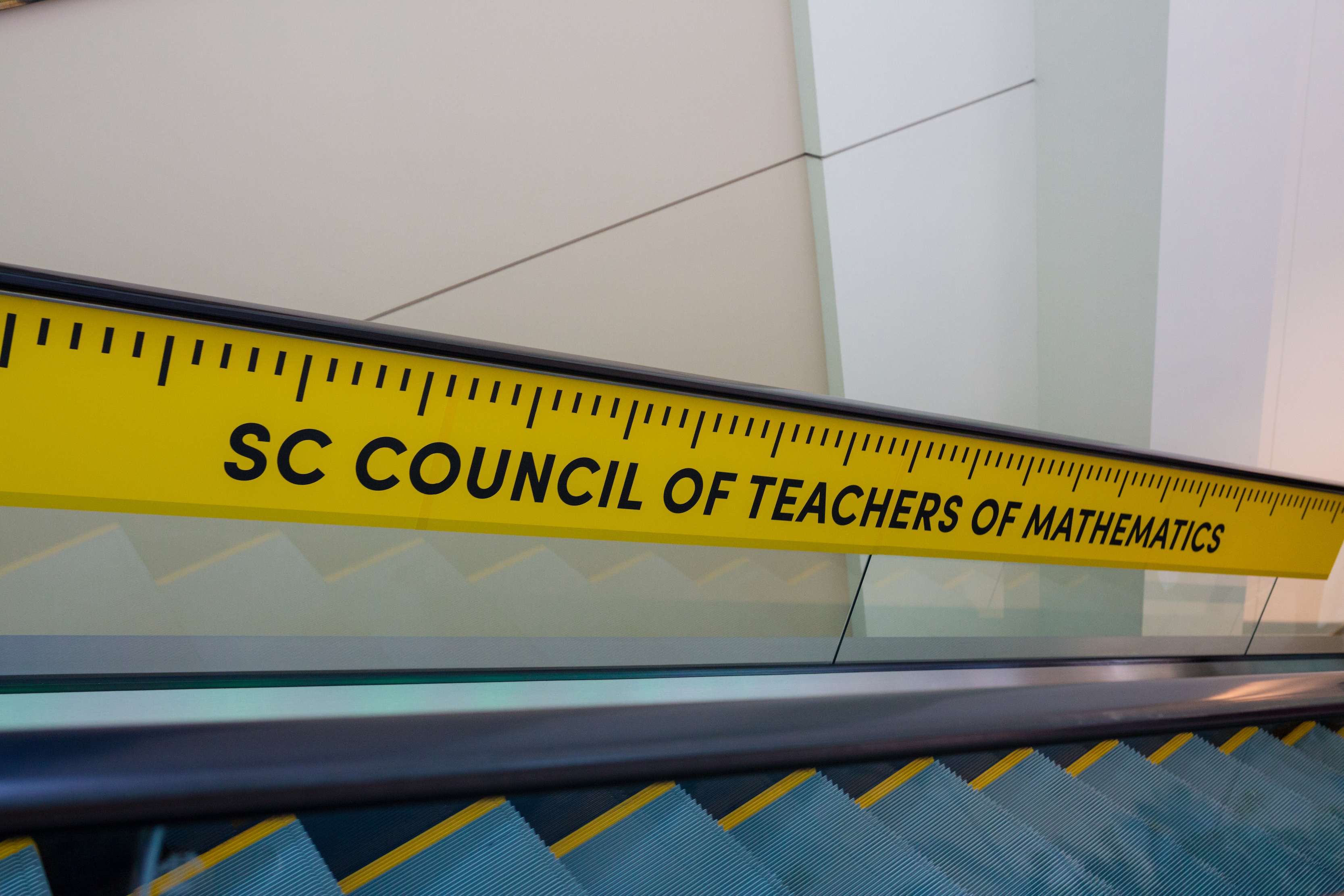 Ruler decoration clinging to the side of an escalator