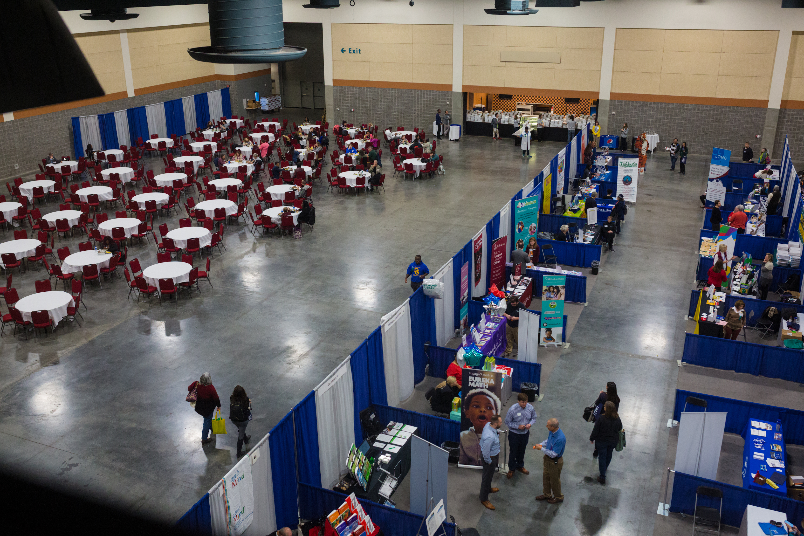 An overhead shot of the Exhibit Hall, doubling as a vendor exhibition space and lunch room